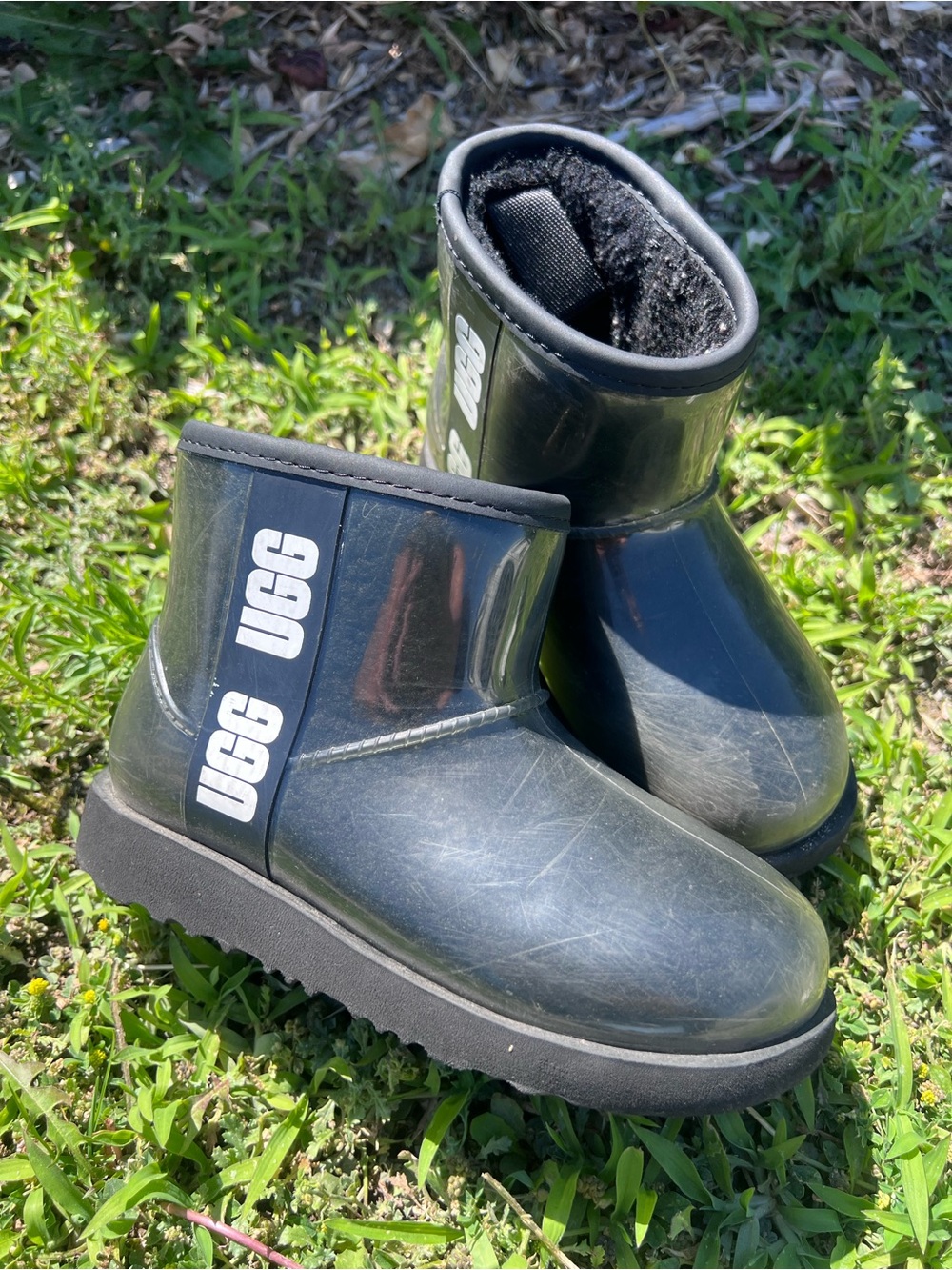 black UGG Classic Clear Mini boots feature a transparent waterproof outer shell